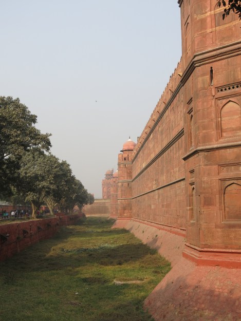 Approaching entrance gate along massive sandstone walls of Red Fort